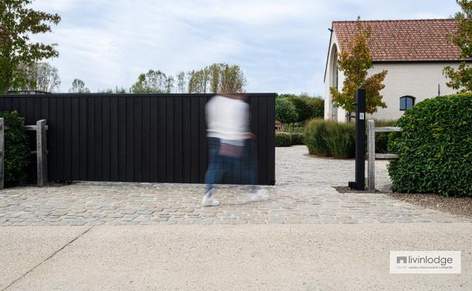 Elegant and harmonious sliding gate in black wood