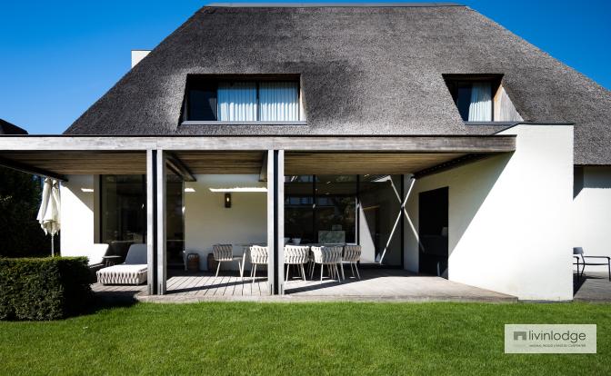 A wooden louvered pergola for a home extension