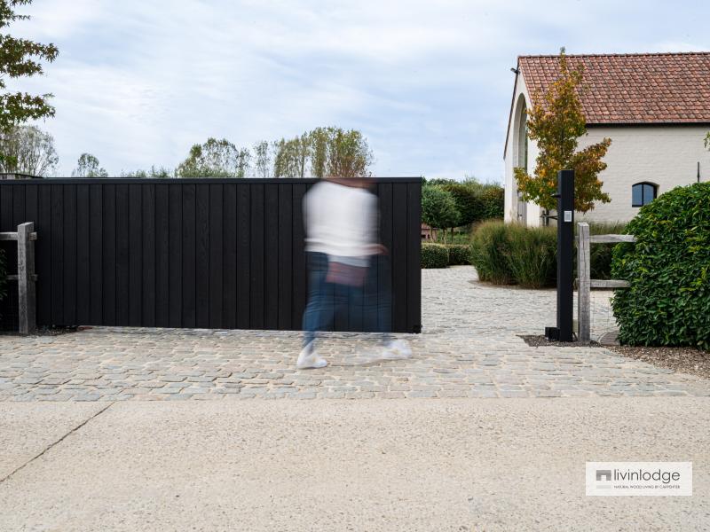 Elegant customised sliding gate in black wood