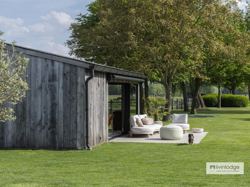 Luxurious garden room in barnwood with a view of the green landscape of the Damme polders