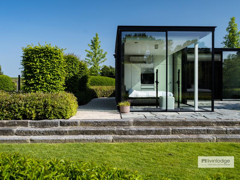 The guest space in the wooden outbuilding features large windows