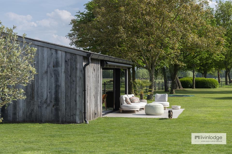 Luxurious garden room in barnwood with a view of the green landscape of the Damme polders